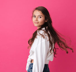 Women with long hair and white shirt on pink background